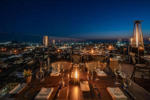 a restaurant with a view of the city at night at Hotel Dom Henrique - Downtown in Porto