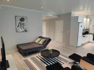a living room with a couch and a table at LENA - Brand new apartment - Modern & Cozy in Närpes - Built in 2023 in Närpiö