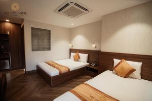 Postel nebo postele na pokoji v ubytování Nét Việt Hotel Vincom Sóc Trăng