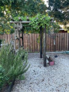 a garden with a pergola with plants on it at Knysna's Rest in Brenton-on-Sea