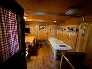 a small room with two beds in a cabin at Mountain Lodge Suška Koča in Stahovica