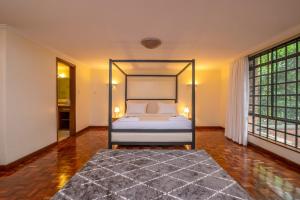 a bedroom with a bed with a black frame at Riverside Park Complex in Nairobi