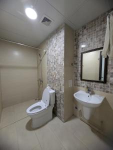 a bathroom with a toilet and a sink at Era Apartment Lac Long Quan in Hanoi