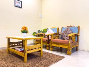 a room with three chairs and a table at Pinaki Comfort Stay Vile Parle - Near Airport in Mumbai +45 photos