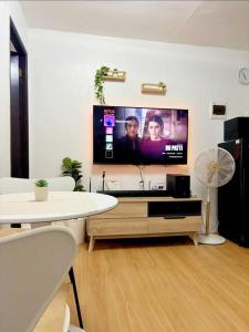 a living room with a flat screen tv on the wall at Korean Themed 1BR Staycation in Marilao Bulacan in Marilao
