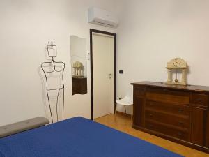 a bedroom with a dresser and a mannequin on the wall at B&B La Casa Mè in Francavilla al Mare