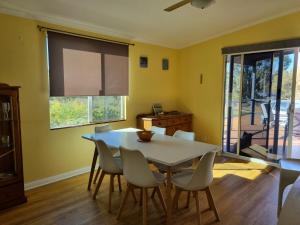 a dining room with a white table and chairs at Lavender Cottage at Nannup Lavender Farm in Nannup Mill