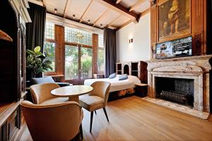a bedroom with a bed and a fireplace at novallure nassau residence in The Hague