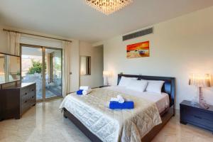 a bedroom with a bed with two blue boxes on it at Villa Pandora Limni by Villa Plus in Mavroli +24 photos