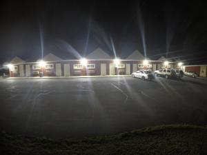 a parking lot with two cars parked in front of a motel at Castle Inn East Greenbush Castleton-on-hudson in East Greenbush