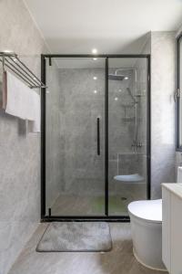 a bathroom with a glass shower and a tub at Sunset Skyline Alba by YourHost1 bedroom Nairobi in Nairobi