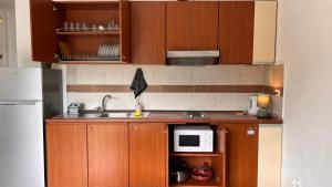 a small kitchen with a sink and a microwave at Kate Apartment in Durrës
