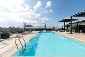 a swimming pool on the roof of a building at Riverside Square By YourHost Nairobi in Nairobi