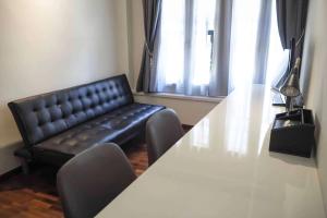 a conference room with a table and a leather couch at Heritage Collection on Boon Tat in Singapore