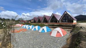 a group of tents sitting on the gravel in front of a building at Villa Annisa 2 in Alahanpanjang