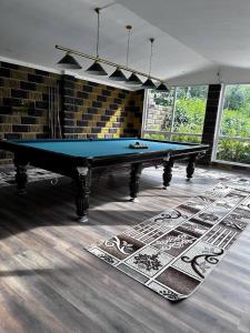 a ping pong table in a room with at Yasina in Bosteri