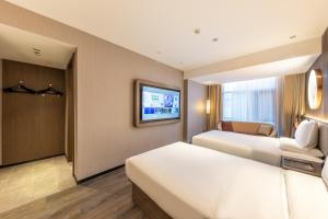 Ліжко або ліжка в номері Xi'an Big Wild Goose Pagoda Tang Dynasty Everbright City Orange Crystal Hotel