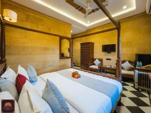 a bedroom with a large bed and a living room at Hotel Sky Residency With Swimming Pool in Jaisalmer
