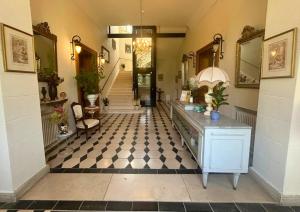 a hallway with a room with a checkerboard floor at Château de Saint-Bohaire in Saint-Bohaire