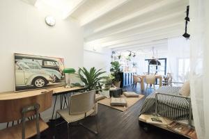 a living room with a table and a car on the wall at The Ombra Small House No.2 in Chiang Mai