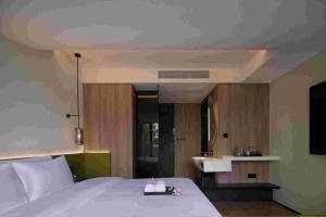 Ein Bett oder Betten in einem Zimmer der Unterkunft Baichuan Business Hotel, Haizhu District, Guangzhou