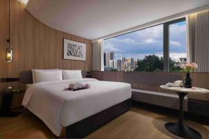 Ein Bett oder Betten in einem Zimmer der Unterkunft Baichuan Business Hotel, Haizhu District, Guangzhou