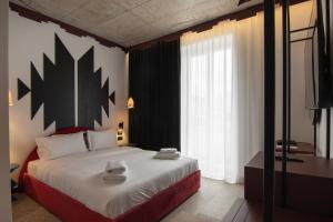 Postel nebo postele na pokoji v ubytování Bazaar Hotel
