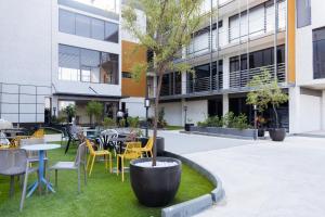 a courtyard with tables and chairs in front of a building at 38 on Boulders Hotel in Gaborone