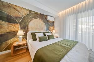 a bedroom with a bed and a large wall at In-Town Residences in Funchal +165 photos