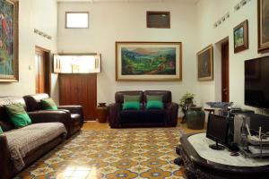 a living room with a couch and a tv at Omah Gerjen 29 in Yogyakarta