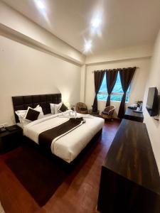 Postel nebo postele na pokoji v ubytování Hotel Mazong Crest