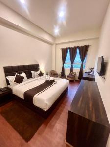 Ένα ή περισσότερα κρεβάτια σε δωμάτιο στο Hotel Mazong Crest