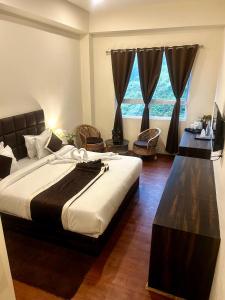 Ένα ή περισσότερα κρεβάτια σε δωμάτιο στο Hotel Mazong Crest