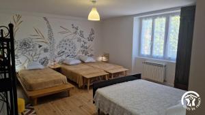 a bedroom with two beds and a window at La maison de prat coutel in Labastide-de-Lévis +38 photos