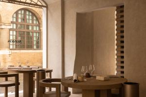 a restaurant with two tables and chairs and a window at Nomos Hotel in Rome