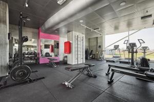 a gym with several treadmills and machines in a room at Cabinn Metro in Copenhagen