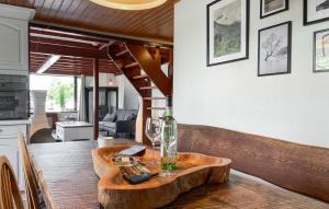 a wooden table with a wine glass and a bottle at Woonboot De Karekiet in Loosdrecht