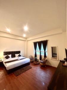 Ένα ή περισσότερα κρεβάτια σε δωμάτιο στο Hotel Mazong Crest