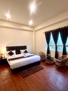 Ένα ή περισσότερα κρεβάτια σε δωμάτιο στο Hotel Mazong Crest