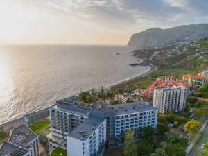 an aerial view of a city and the ocean at In-Town Residences in Funchal