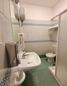 a bathroom with a sink and a toilet at Agenzia Isotur MARI DI LEVANTE in Ponza
