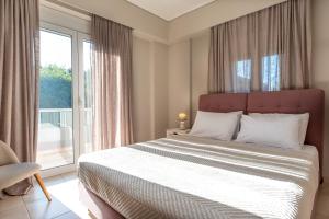 a bedroom with a large bed and a large window at DreamCoast Apartments I in Artemida +113 photos