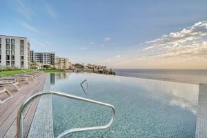 a swimming pool with a view of the ocean at In-Town Residences in Funchal