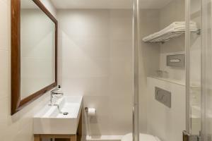 a bathroom with a toilet and a sink and a shower at Best Western Aramis Saint Germain in Paris