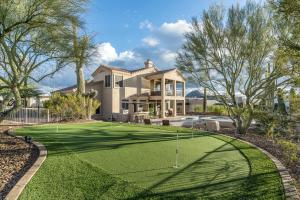 a golf course in front of a house at Pinnacle Perfection by Porter Heated Pool Spa w Outdoor Putting Green in Scottsdale