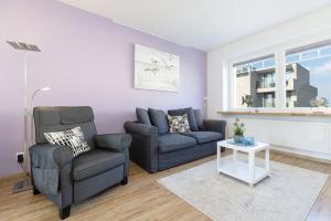 a living room with a couch and a chair at Strandkrabbe in Laboe +34 photos