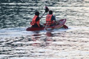two people in a kayak on a body of water at Bottle Beach 2 Bungalows in Bottle Beach