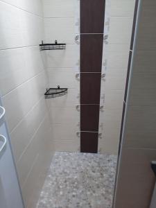 a walk in shower with white walls and shelves at Gîte chez Marie et Franck in Barbaste +19 photos