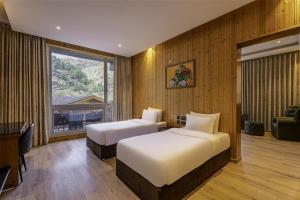 Rúm í herbergi á Palchan Hotel & Spa - A member of Radisson Individuals Retreats