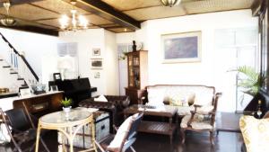 a living room with chairs and a table at Villa Mungkala in Bangkok